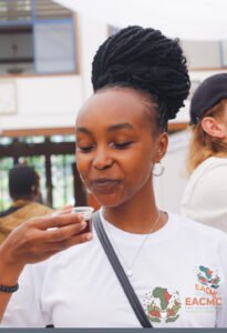 A visitor tasting coffee during EACMC 2025