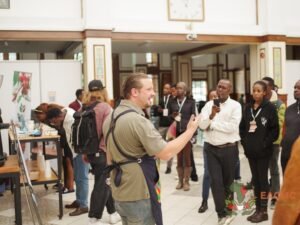 A coffee professional leading a live demonstration for EACMC visitors