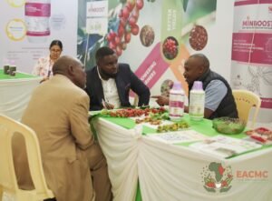 Exhibitors discussing coffee products and partnerships at EACMC 2025